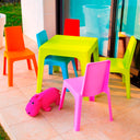 Conjunto Infantil Julieta con mesa naranja y 4 sillas multicolor para niños.